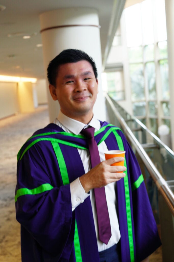 Joel holding a cup